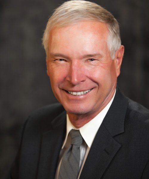 headshot of Larry Emerson smiling and wearing a suit